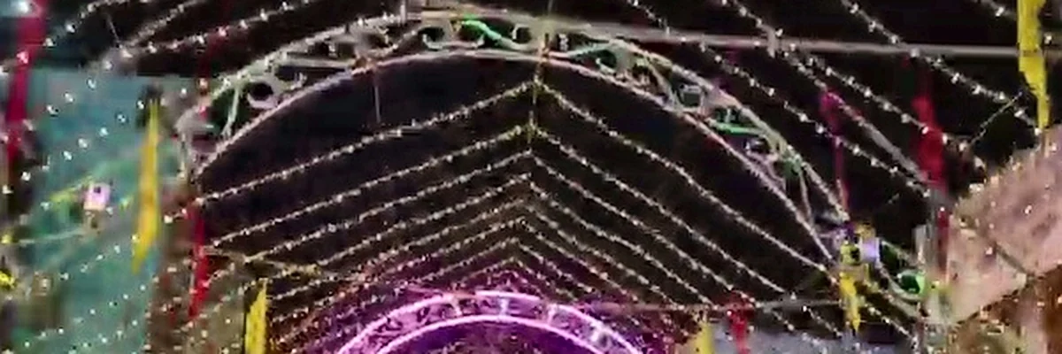 Overhead vaulted illumination tunnel canopy bathing Dhenkanal streets in vibrant light