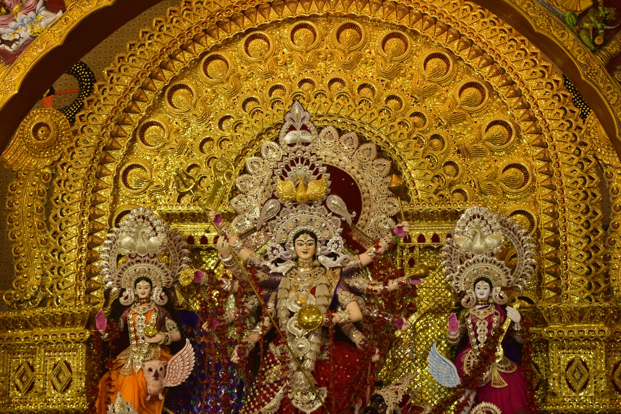 Detachable Suna Medha gold arch and Chandi Medha silver panels mounted around clay Durga idol before post-puja dismantling