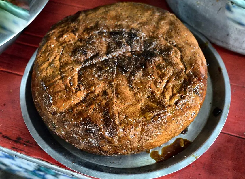 Authentic caramelized Dhenkanal chhena poda cheese cake wheel slow baked in sal leaves over charcoal