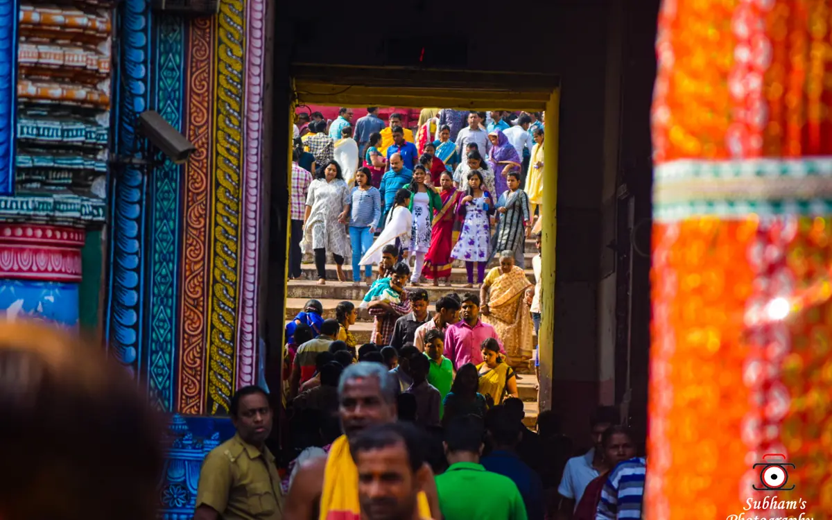 Women wearing long kurtis, churidar, salwar kameez, and traditional sarees ascending the Baisi Pahacha steps at Puri Jagannath Temple