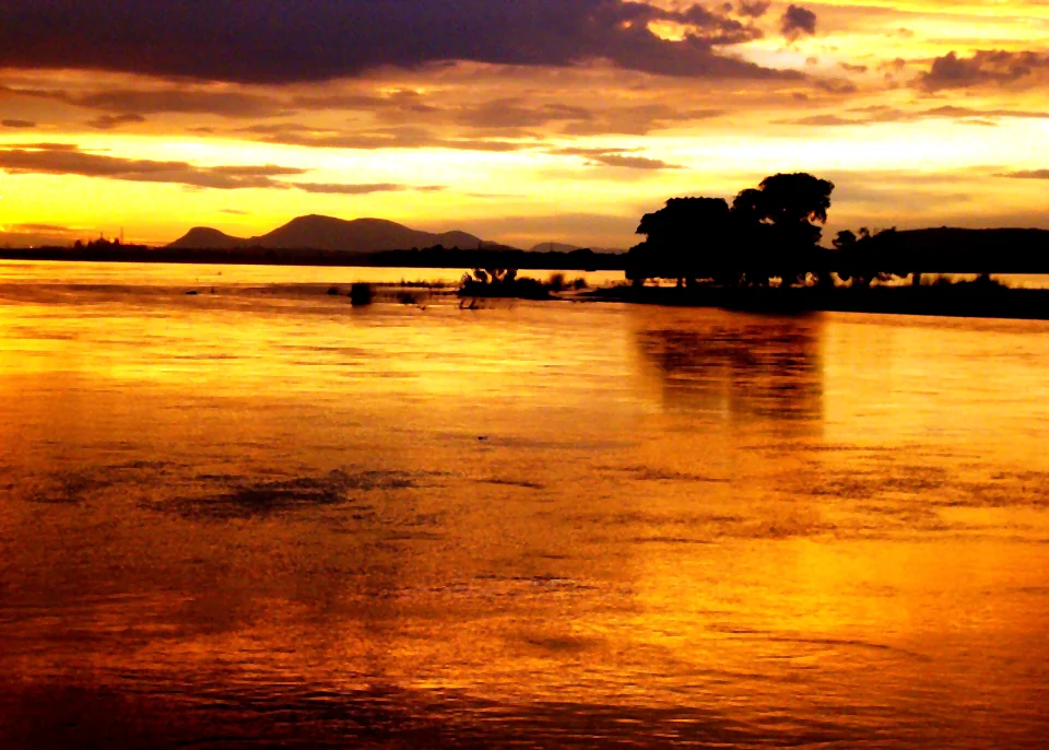 Sunset over the Mahanadi River at Chahata, Cuttack, with hills on the far bank